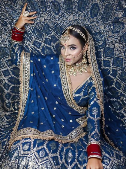 A full-length shot displaying the entire blue lehenga, giving a complete view of the styling.