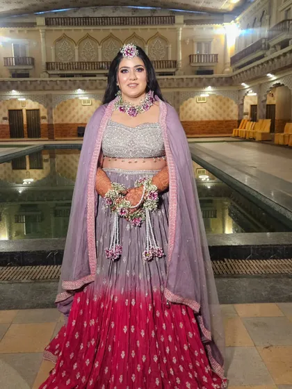 A stunning Haldi look in a unique lavender and pink ombre lehenga. The floral jewelry was custom-made to match the outfit.