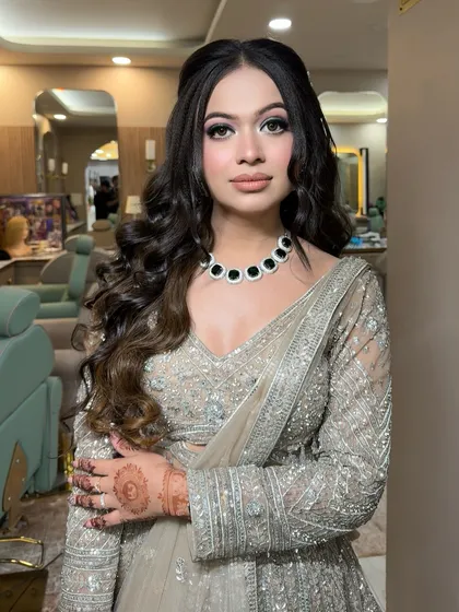The full look, showing the beautiful soft waves and the perfectly sculpted makeup. This is a popular choice for sangeet or cocktail parties.