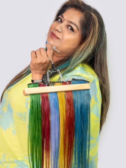 I'm holding a hanger of our vibrant Colour Strands. From green and red to blue and yellow, you can choose any color to match your mood or outfit, all without damaging your hair.