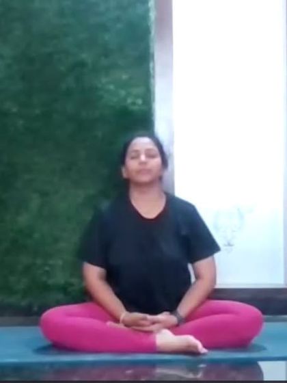 An instructor sits in Padmasana (Lotus Pose) for meditation during an online class. We guide students towards achieving such classic meditative postures with patience and proper technique.