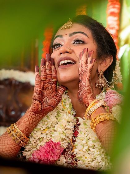 A moment of pure joy. This close-up highlights the bride's expressive happiness, with her makeup looking fresh and radiant.