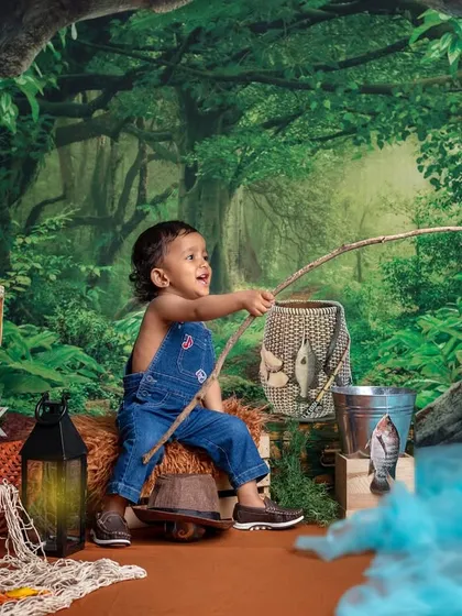 A little fisherman's big catch of the day! I love creating these imaginative worlds where your child can be anything they dream of, like a fishing buddy in a forest.