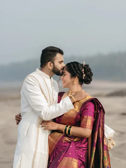 A tender forehead kiss against the serene backdrop of the sea. This shot captures a quiet promise, showcasing our ability to create deeply emotional portraits during destination weddings.