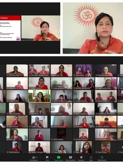 A detailed look into our online prosperity workshop, focusing on the Muladhara (Root) Chakra. Maa Aditiji is seen guiding the session, explaining the chakra's role in stability and grounding, alongside a grid of attentive participants.