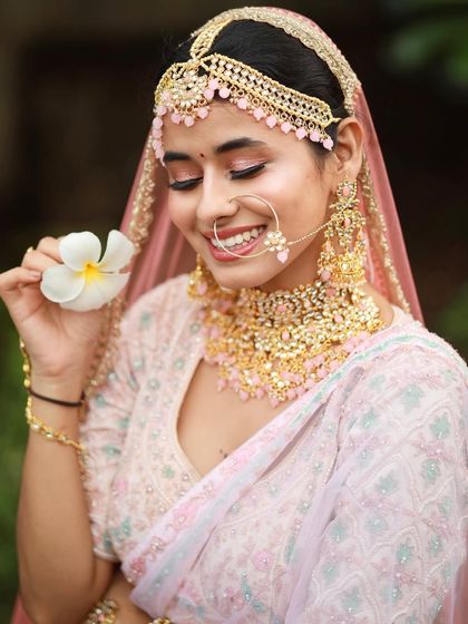 This bride sets a new standard for beauty with her soft, pastel look. The makeup is ethereal and romantic, with a focus on pink tones and a dewy finish.