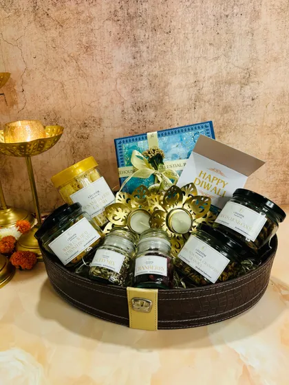 This grand festive basket for Diwali is overflowing with our finest treats. It includes multiple jars of our granola, cookies, and other healthy snacks, centered around a decorative diya holder.
