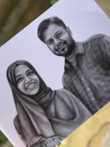 The finished A4 couple sketch from Kerala, pictured outdoors to show the drawing in natural light.