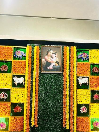 A full view of the marigold checkerboard backdrop, a popular choice for traditional ceremonies like baby showers and haldi events.