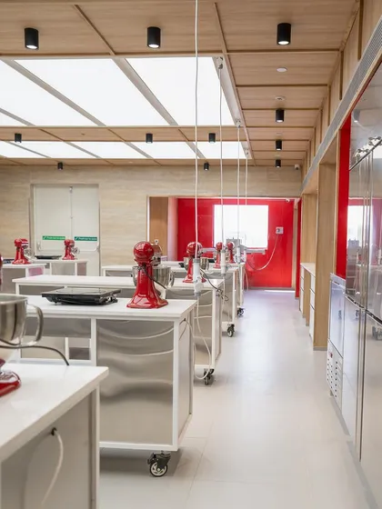 A side view of the kitchen classroom, showing the clean lines and efficient workflow of the space.
