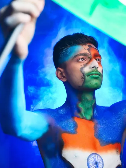 A dynamic shot of the Republic Day body paint, with the model holding the flag high.
