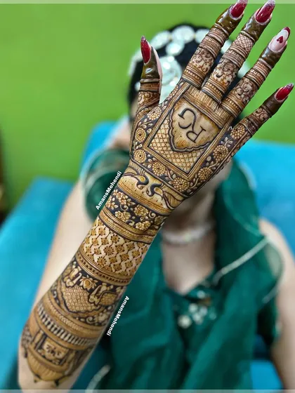 The initials 'R' and 'G' are the centerpiece of this intricate back-of-hand design, perfect for an engagement or wedding.