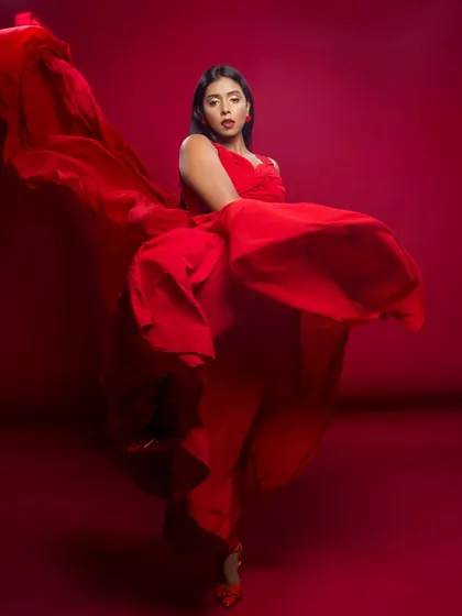 A powerful pose with the red dress, showing its movement and vibrant color. This is a classic 'wow' shot for any portfolio.