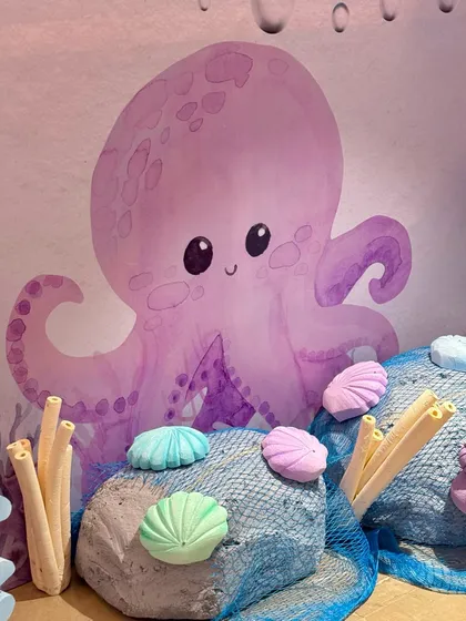 The details of our mermaid party included custom-designed treat boxes with seahorses and shells, and adorable octopus characters that added to the underwater fantasy.