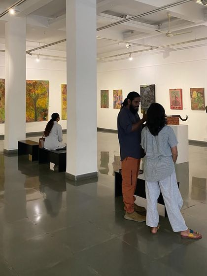 The artist in conversation with visitors in the gallery.