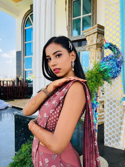 A beautiful portrait of this bridesmaid. The makeup is youthful and fresh, with a pop of pink on the eyes and lips that complements her dusty rose outfit.