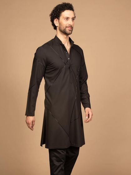 This black kurta is the epitome of comfort and elegance. The structured design with diagonal seam detailing gives it a modern and edgy feel, perfect for a man with a contemporary sense of style.