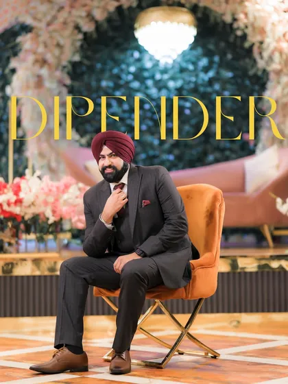A stylish solo portrait of the groom, Dipender, seated and looking dapper in his three-piece suit.
