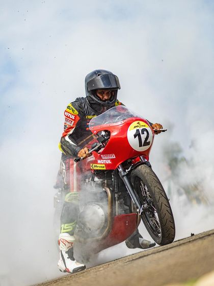 A classic burnout on a Royal Enfield Continental GT, creating a massive plume of smoke. This is a crowd-pleasing stunt that demonstrates raw power and is a staple of our performance repertoire.