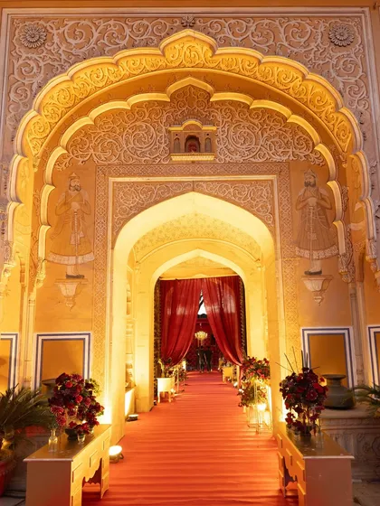 The ornate, beautifully lit entrance to the palace wedding venue. We use lighting to highlight the intricate architectural details, welcoming guests into a world of heritage and luxury.