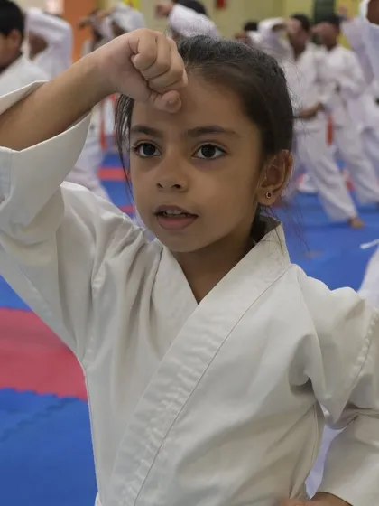 A young student demonstrates a forward block during her belt exam. We teach children as young as five, instilling focus and discipline from an early age.
