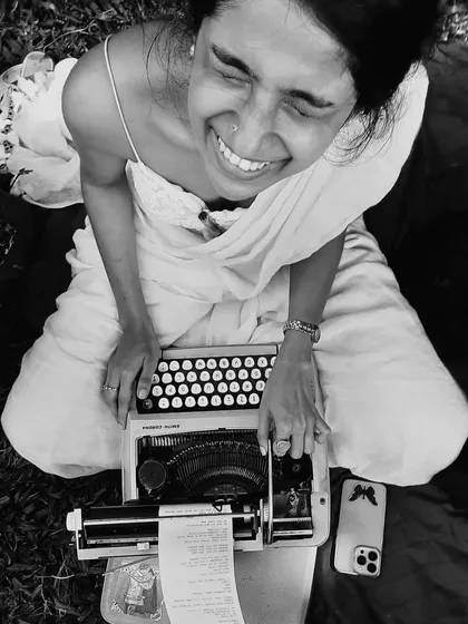 A moment of pure, unbridled joy captured between poems. This is me in my element, surrounded by nature, with my trusted typewriter, doing what I love most. This black and white photo perfectly captures the timeless feeling of creating art from the heart.