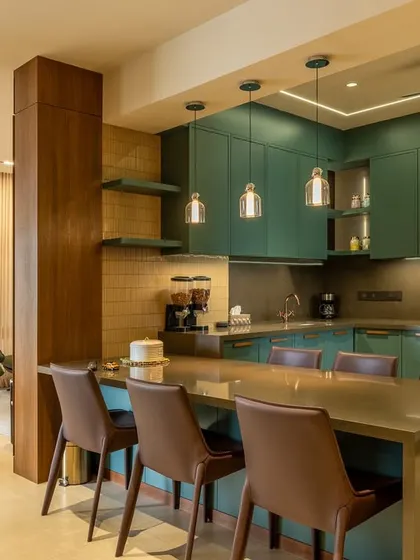 The kitchen is the heart of the home, and in the Humaize Apartment, we created one that is both functional and beautiful. This open-concept kitchen features deep teal cabinetry, a breakfast bar, and custom lighting, seamlessly connecting to the living area.