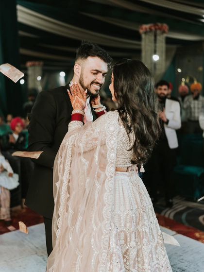 Capturing the pure joy of a reception party. This candid shot shows the bride and groom dancing, with her makeup looking flawless even in the middle of the celebration.
