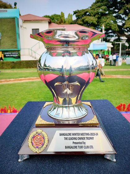The Leading Owner Trophy, a classic silver vase design.