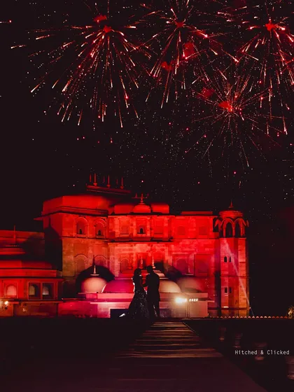 A silhouette of the couple against a sky of red fireworks. These are the iconic, powerful images that I strive to create, turning your wedding into a timeless story.