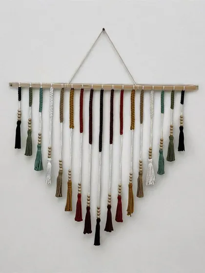 This colorful V-shaped wall hanging is a piece of art for your home. I carefully select each color and knot every tassel by hand to create a vibrant design that brings joy to any room. It's a perfect statement piece for a living room or entryway.