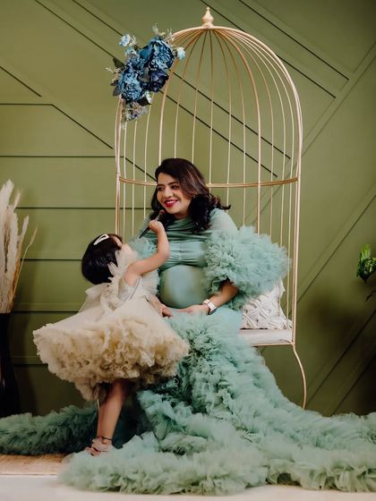 Such a sweet moment between mother and daughter during their family maternity shoot. The little one is helping her mommy get ready, showing the loving bond they share.