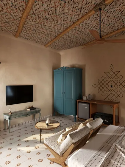 A wider view of the suite, showing how the *kolam* art piece is integrated into the overall living space. The pop of blue from the vintage-style armoire adds a surprising and delightful contrast to the neutral, earthy palette.