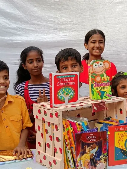 The joy of receiving a new book is universal. These children from the Umang Foundation collaboration couldn't wait to start reading.
