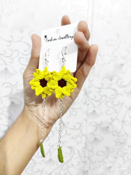 My popular dangling sunflower earrings. These feature a bright yellow sunflower top with a delicate chain leading to a small crocheted leaf.