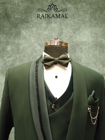 This olive green three-piece tuxedo is a modern classic. The design features a unique asymmetrical lapel and is crafted for a sharp, tailored fit, ideal for a wedding guest or a festive event.
