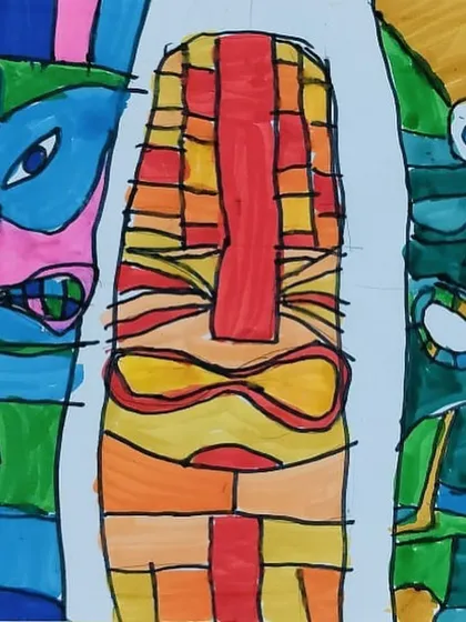A close-up of the abstract totem pole faces, showing the intricate patterns and bold color choices made by the student.