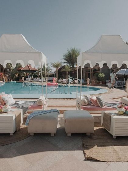 The chic poolside setup with cabanas and comfortable lounge seating for the post-wedding brunch party.