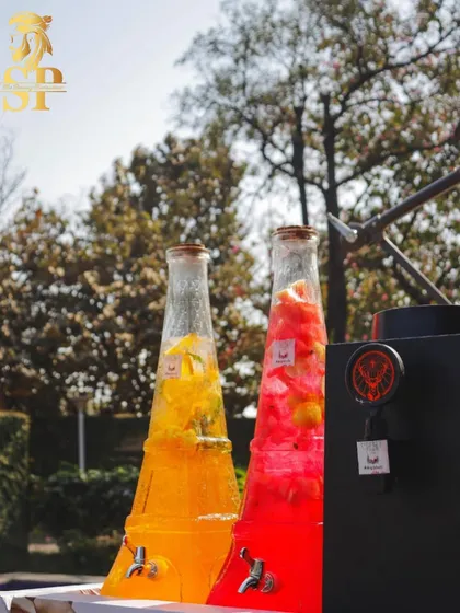 Our Eiffel Tower drink dispensers filled with colorful fruit-infused cocktails. They are not just functional but also a beautiful decorative element for the bar.
