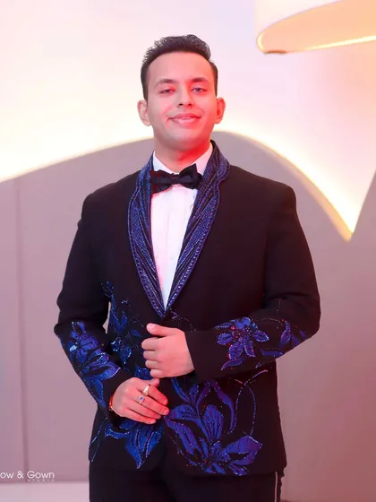 A portrait of the groom looking sharp and happy on his engagement day. His stylish tuxedo with blue floral details really stands out in this shot.