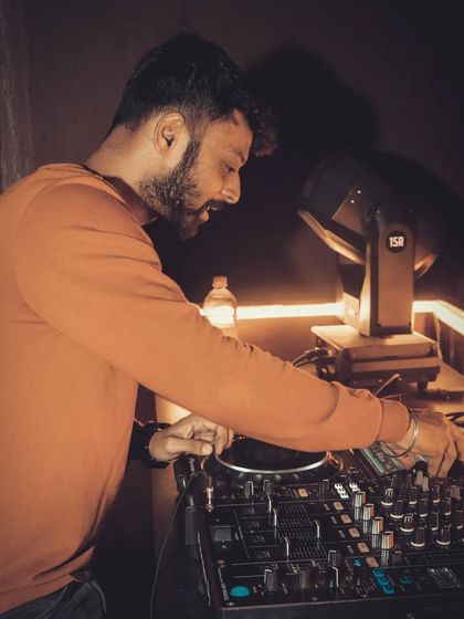 It's all about the vibe. A shot of me mixing in a warmly lit room.