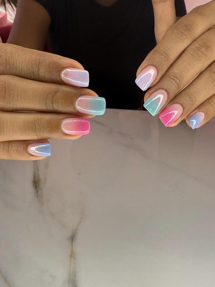 The perfect summer nails in a soft pastel rainbow. This design features a beautiful ombre effect on each nail, blending shades of blue, pink, and lavender.