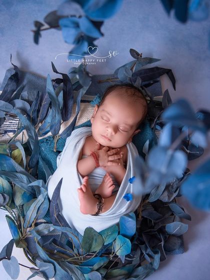 Wrapped in white and surrounded by blue eucalyptus leaves. This overhead shot is clean, modern, and beautifully composed, with a calming color palette.