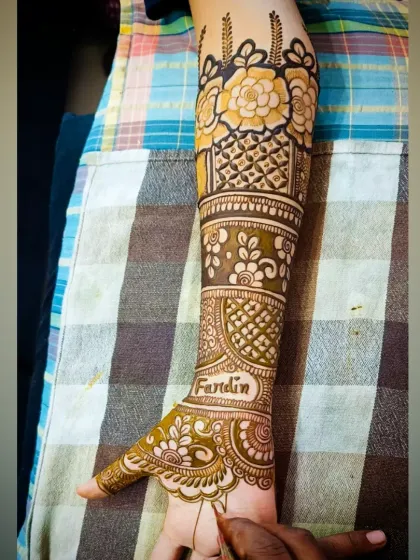 A detailed view of the arm with the name "Fardin," showcasing the surrounding floral and geometric work.