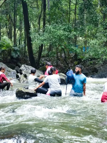 Helping each other navigate the river currents. Our experienced guides ensure your safety during all adventure activities.