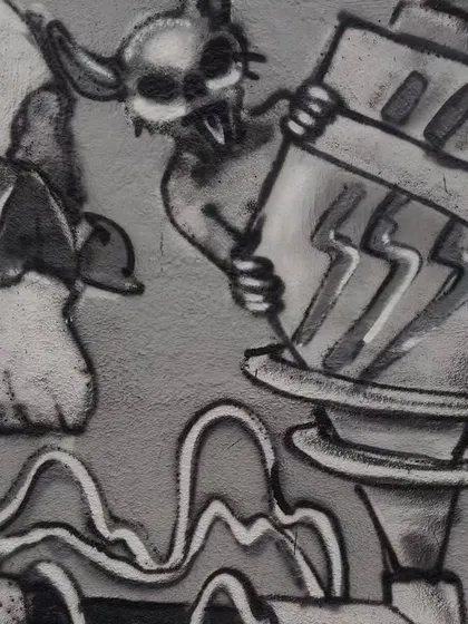 A close-up of the cow skull and a small demonic character from the mechanical mural. The shading and detail work here are done entirely with spray paint, creating a gritty, textured look.
