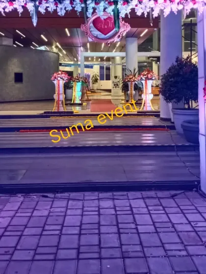 This image shows how my decorations can enhance a venue's entrance. The floral arrangements on the pillars guide guests inside and set a festive tone from the moment they step out of their car.