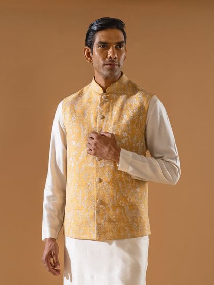 A close-up of a pale yellow Jawahar jacket with subtle, tone-on-tone embroidery. This piece exemplifies understated elegance and is a versatile addition to any festive wardrobe.