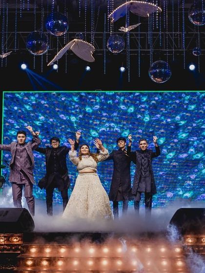The bride and her brothers take center stage, surrounded by smoke for a dramatic and powerful performance.