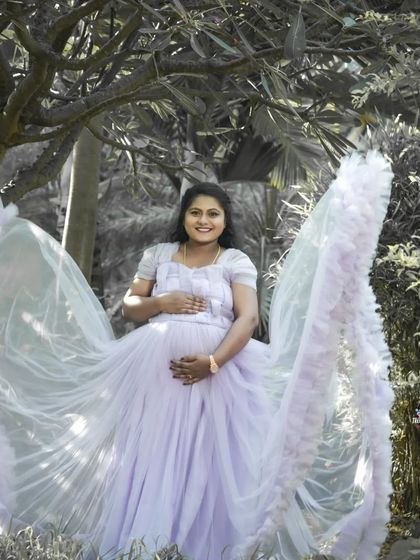 A creative solo portrait using a black and white effect on the background to make the subject and her flowing lavender gown stand out. This technique adds an artistic and dramatic flair.